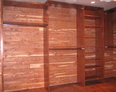 an empty room with wooden walls and shelves