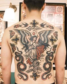 the back of a man with tattoos on his body