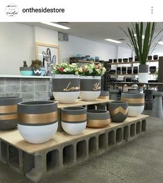 several bowls and vases on display in a store