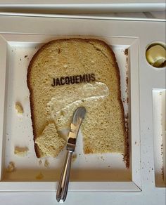 a piece of bread with the word jacquemus on it and a fork