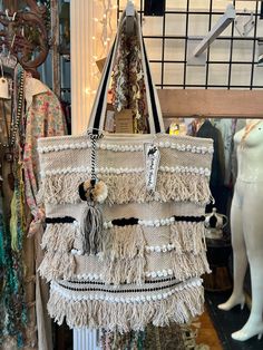 Jet set in style with this 00A7 Miami fringe tote bag! Get ready to turn heads with its natural color, playful tassels, and fashion-forward look. Feel like a celeb while you trot around town for the ultimate travel get away! White Tassel Shoulder Bag For Travel, Trendy Tassel Travel Bags, Trendy Travel Bags With Tassels, Trendy Tote Beach Bag With Tassels, Trendy Beach Tote Bag With Tassels, Beige Tasseled Bags For Travel, Trendy Tassel Beach Tote Bag, Casual Beach Bag With Tassels For Shopping, Summer Tote Shoulder Bag With Tassels