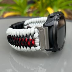 Welcome to Cording2U. We are excited to craft your new personalized custom watch band strap. Please visit our shop for more ideas https://cording2u.etsy.com/ We are a US Military Veteran Owned Business  Thank you for your support🙏 Handcrafted with 100% Nylon Paracord "MADE IN USA".   ⚠️GARMIN FENIX 7 SERIES, AND EPIX (Gen 2) MUST SELECT QUICK RELEASE ADAPTERS as the original metal bar is not removable.  ⚠️Please, make sure you are able to remove the spring or metal bar from your watch before requesting "No Adapters". ⚠️Hemsut adapters not recommended for Instinct model. Our Products include:    ➖Custom handmade watch bands "According to You". No matter how small or big your wrist size, we will craft your perfect fitting band (wrist size picture measurement required).  ➖Variety of styles t Adjustable Watch Accessories With Analog Display For Outdoor, Durable Silver Watch Bands For Outdoor, Silver Durable Watch Bands For Outdoor, Outdoor Durable Silver Watch Bands, Adjustable Silver Watch Bands For Outdoor Use, Paracord Watchband, Paracord Bracelet Designs, Paracord Armband, Paracord Braids