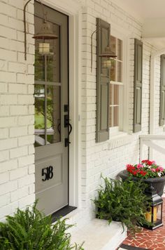 two potted plants on the front steps of a house