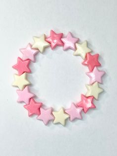 Shades of pink plastic stars on a stretchy bracelet make this bracelet the cutest!  Bracelets are available in a variety of lengths.  Pick your custom length from the drop down menu below.  Please be aware that beading may slightly differ from what is pictured as to accommodate selected sizing.  All our bracelets are made with quality in mind.  With that being said, all bracelets should be treated with care while putting on, wearing, and taking off.  Keep dry. Do not swim or bath with them. Pink Kawaii Beaded Bracelets For Birthday, Pink Star-shaped Jewelry For Friendship, Pink Star-shaped Friendship Bracelets, Pink Star-shaped Friendship Jewelry, Adjustable Pink Star Bracelets, Cute Pink Plastic Bracelets, Cute Pink Star-shaped Bracelets, Pink Star-shaped Kawaii Jewelry, Pink Plastic Bracelets For Friendship