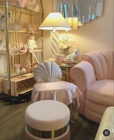 a living room filled with furniture next to a mirror and lamp on top of a hard wood floor