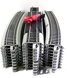 two sets of train tracks connected to each other with red wires on the top and bottom