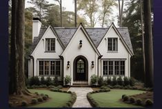 a white house surrounded by trees and bushes in front of the door is an entry way