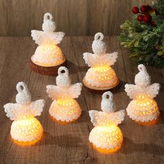 small crocheted angel ornaments on a wooden table