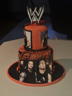 a cake decorated with wrestling pictures on it