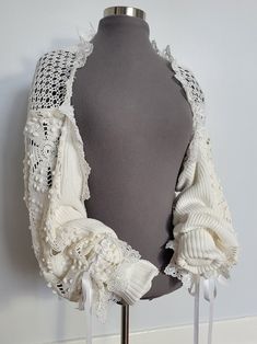 One of a kind upcycled patchwork bolero jacket handcrafted from a circa 1950s crochet blanket, vintage crochet table runner and preloved sweater. Adorned with ribbons and lace. The shoulder has elastic to help preventing the jacket from sliding off the shoulders. Cuffs can be unrolled to fit longer arms. 100% off-white/ivory cotton.  White trims, new material. Doing my part to help save our planet. 10% of all sales will be donated to Greenpeace. Crochet Garments Free Patterns, Boho Upcycled Clothing, Bolero Jacket Outfit, Upcycle Crochet, 1950s Crochet, Crochet Materials, Bolero Crochet, Crochet Garments, Vintage Bridesmaid Dresses