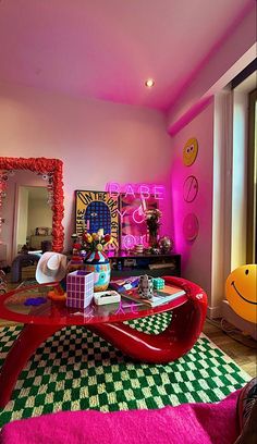 a living room decorated in pink and green with black and white checkered flooring