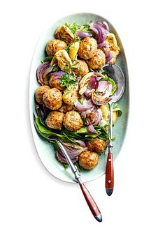 a white plate topped with meatballs and vegetables