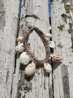 Crocheted Rustic Hemp Bracelet with Shell Crams Natural Beach Jewelry, No Metal, Hemp Rope Bracelet The base of this bracelet is a crocheted hemp rope (The most time-consuming part of this design.) The various small shell beads are also crocheted around the natural rope. the bracelet has a loop-knob closure. (I drilled the holes on every shell.) This one is for an average wrist, but feel free to request a different size. Handmade Brown Braided Bracelets For Beach, Beach Brown Macrame Braided Bracelet, Woven Beaded Bracelet For Beach, Bohemian Crochet Jewelry For The Beach, Bohemian Crochet Jewelry For Beach, Bohemian Adjustable Crochet Beaded Bracelets, Bohemian Crochet Beach Jewelry, Bohemian Adjustable Beaded Crochet Bracelets, Handmade Beige Bracelets For Vacation