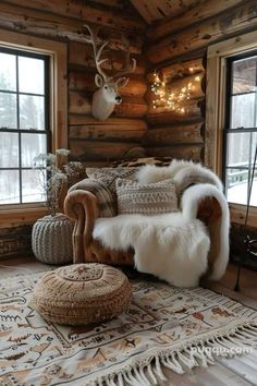 a living room filled with furniture and lots of windows covered in deer antlers on the wall