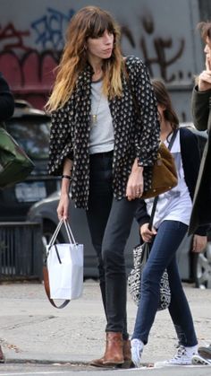 two women walking down the street talking to each other