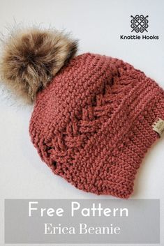 a knitted beanie hat with a pom - pom on the top