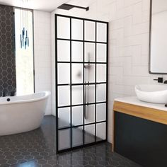 a modern bathroom with black and white tiles on the floor, tub, sink and mirror