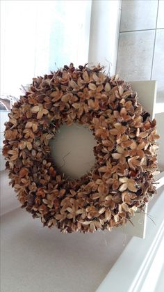 a wreath is sitting on the window sill