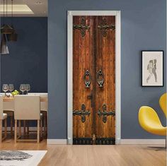 an open door in a blue room with yellow chairs and pictures on the wall behind it