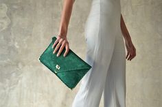 "The perfect bag for all day needs, evening entertainment and going to a party. This adorable bag is handmade out of a beautiful high quality, emerald green suede Italian leather. It is hand stitched with green waxed thread. The color of the waxed thread can change upon request. The interior is fully lined with beige leatherette. The clutch closes with a metal twisted clasp and has metal endings, available in silver and gold color. The pictures show the clutch with gold metal hardware. Dimension Green Leather Clutch For Evening, Green Leather Evening Clutch, Chic Green Pouch Evening Bag, Chic Green Clutch Evening Bag, Elegant Handmade Green Clutch, Elegant Green Envelope Clutch, Elegant Handmade Green Evening Bag, Elegant Green Handmade Evening Bag, Green Envelope Clutch For Everyday Use