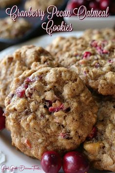 cranberry pecan oatmeal cookies are stacked on a white plate