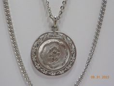 "Vintage silver tone pendant necklace. 18\" & 26\" silver tone chains attached to a 1 1/4\" diameter pendant with a raised rose in the direct center. Pretty! Spring ring fastener. Excellent vintage condition." Silver Necklace With Curb Chain And Round Pendant, Silver Medallion Necklace With Curb Chain, Silver Medallion Necklace With Chain, Silver Medallion Necklace With Chain As Gift, Vintage Silver Curb Chain Jewelry, Vintage Silver Jewelry With Curb Chain, April Showers, Double Chain, Spring Rings