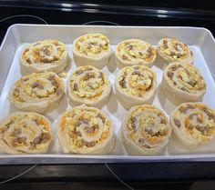 there are many different types of food in the tray on the stove top burner