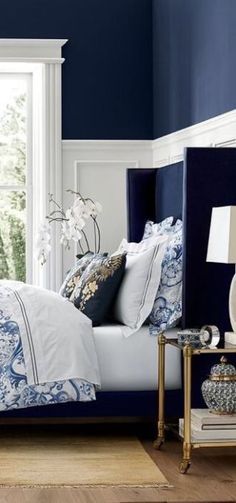 a bedroom with blue and white decor on the walls, along with an instagram