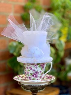 This mini top hat is created entirely in white, and would be perfect for the bride to be! It is made of layers of cardstock & foam, covered with felt, and trimmed with ribbon, tulle, satin rosebuds, faux pearls. Each hat is made to order - if you are interested in other colors, just ask! Add-ons are available it you would like to wear the hat - options include white elastic, a white plastic headband, or two small metal clips. --------------------------------------------------------------------------------------------------------------------------------- Approximate measurements: Height of hat = 4 inches Brim of hat = 4.5 x 5 inches --------------------------------------------------------------------------------------------------------------------------------- Thank you for looking! :) You Adjustable Mini Hats For Royal Ascot, Adjustable Mini Hats For Royal Ascot Gift, White Mini Hats For Royal Ascot, White Fascinator For Kentucky Derby Gift, White Adjustable Costume Hat With Pinched Crown, White Costume Hat With Round Crown For Parties, Kentucky Derby Short Brim Top Hat Gift, Kentucky Derby Gift Top Hat With Short Brim, Adjustable High Crown Mini Hat As A Gift