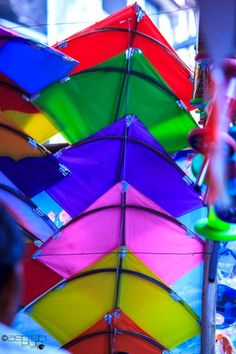 many colorful umbrellas are hanging in the air