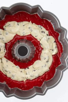 a bundt cake with white icing and chocolate chips in it on a red plate