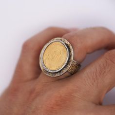 22K Gold and Sterling Silver Justinian Byzantine Empire 22k gold coin bezel set mens ring. The coin originates from the Byzantien Empire, while the ring was likely a late Victorian era make. The ring is rich with history, bearing its incredible age and antiquity on its sleeve. The bezel and shank have a unique texture and splash of gold to them.   JUSTINIAN I Byzantine Empire (527-565), AV Solidus (4.32g) coin, 22k gold  DN IVSTINI ANVS PP AVG Helmeted & cuirassed bust facing, hidg gl. Cr. & shield / VICTORIA AVGGG I Angel stg facing, long cross Extra Fine  Details: Item Type: Antique Ring Metal type: Sterling Silver Weight: 21.6 Grams Setting: Bezel  Size: 9 3/4 Color: Gold  Centerpiece Details: 22K Gold Coin, Byzantine Empire Era Gold Coin-shaped Engraved Signet Ring, Gold Engraved Coin Signet Ring, Gold Coin-shaped Engraved Ring, Gold Byzantine Engraved Signet Ring, Gold Coin-shaped Ring For Anniversary, Gold Coin-shaped Anniversary Ring, Formal Byzantine Gold Signet Ring, Formal Gold Byzantine Engraved Ring, Antique Gold Signet Ring With Bezel Setting