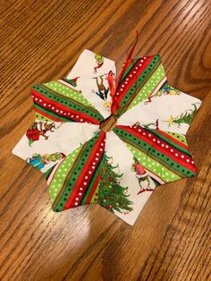 several christmas napkins on a wooden table