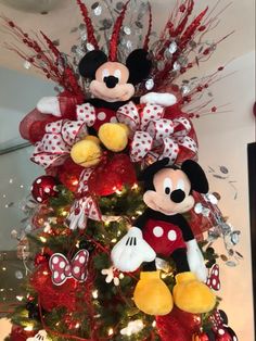 a christmas tree decorated with mickey and minnie mouse decorations