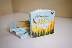 three children's books sitting on top of a white table next to each other