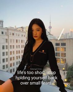 a woman is posing in front of a cityscape with the words life's too short, stop holding yourself back over small fears