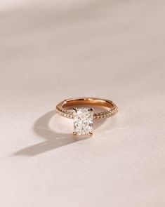 an engagement ring with a cushion cut diamond