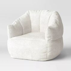 a white chair sitting on top of a white floor