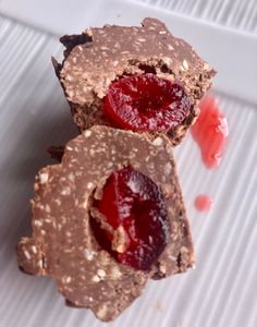 two pieces of chocolate with cherries on top