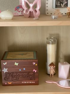 a shelf with various items on it including a candle, toothbrush and soap dispenser