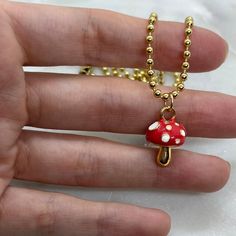 "So cute! You'll look so adorable with this red and gold plated mushroom charm pendant necklace. Perfect for nature lovers, cottagecore girls, mushroom lovers and more. Choose your own necklace length from 14\", 16\", 18\" or 20\" for Gold Plated Mushroom Necklace. Charm hangs from a perfect 14k gold plated dainty chain. Chains are high quality gold plating and tarnish resistant. Gold and red enamel with CZ stones.  Necklace comes with 14k gold plated chain 14k gold plated over stainless steal - Nickel and lead free Please chose your chain length preference options available: 14\" (fits like a choker), 16\" (standard necklace length), 18\", 20\" Bring a touch of nature to your wardrobe with this beautiful 14k Gold Plated Red and Gold Mushroom Charm Necklace. Crafted with high-quality mater Brown Mushroom Necklace, Red Mushroom Design Jewelry Gift, Whimsical Gold Jewelry With Mushroom Design, Gold Mushroom Pendant Necklace, Mushroom Design Dangle Jewelry Gift, Mushroom Design Dangle Jewelry As Gift, Mushroom Shaped Necklace For Gifts, Mushroom Design Necklace Gift, Mushroom Design Necklace As Gift