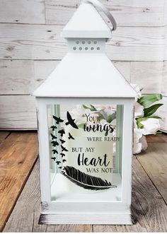 a white lantern sitting on top of a wooden floor