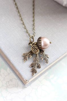 This is a beautiful nature inspired charm necklace! The charm cluster pendant includes a 12mm chocolate brown Swarovski pearl acorn with rustic antiqued brass top, an antiqued gold pine cone with gorgeous details and a woodland branch of three leaves in antique gold brass. The chain length is available in 16" - 26" length. You can select from 15 pearl colors. This necklace will be shipped on a branded necklace display card Wedding Nature, Wedding Autumn, Jewelry Layering, Acorn Necklace, Branch Necklace, Red Pearl, Nature Necklace, Wedding Winter, Red Necklace