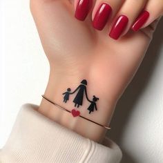 a woman's hand with a small tattoo on her wrist that has an image of a family holding hands