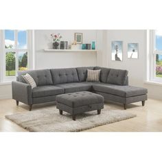 a living room with a gray sectional couch and footstool in front of a window