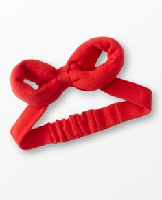 a red headband with a knot on the end and an orange bow at the top