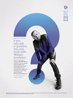 a man standing in front of a blue question mark on the side of a poster