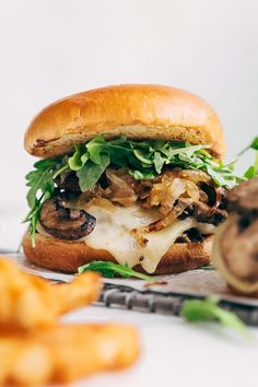 a close up of a sandwich with mushrooms on it