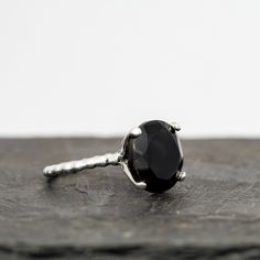 Black Spinel Cocktail Ring in Recycled Sterling Silver, White Gold, Yellow Gold or Rose Gold.12mm round natural black spinel ringSimilar in appearance to black diamond and black onyx, but stronger than onyx- Spinel is polished to a shine and beautifully faceted.Spinel is phenomenally durable, a 9 on the MOHS hardness scale, and this stone is a whopping 12mm across, just around 1/2 an inch.The solitaire sits about 8mm off the finger and pairs nicely with a band ring, or as a solitaire statement r Luxury Black Spinel Diamond Ring, Hardness Scale, Black Spinel Ring, Treasure Jewelry, Spinel Ring, Black Spinel, Recycled Sterling Silver, Cocktail Ring, Black Rings