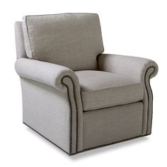 a beige chair with studded trim around the arms